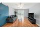 Living room features a sliding glass door, stylish blue accent door, ceiling fan and contemporary furnishings at 3711 W Iowa Ave # 214, Tampa, FL 33611