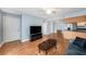 Inviting living room featuring a dark entertainment center, modern decor, and open access to the kitchen at 3711 W Iowa Ave # 214, Tampa, FL 33611