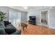 Living space with an entertainment center, light wood-look floors, and sliding glass doors at 3711 W Iowa Ave # 214, Tampa, FL 33611
