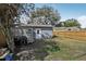 Backyard featuring a utility shed, mature trees, wooden fence, and ample space for outdoor recreation at 4537 22Nd N St, St Petersburg, FL 33714