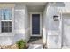Charming front door of a light blue home with well-maintained landscaping and neutral trim at 6307 113Th E Ter, Parrish, FL 34219