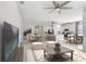 Spacious open-concept living room with modern ceiling fans, neutral decor and eat-in kitchen at 6307 113Th E Ter, Parrish, FL 34219