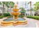 Picturesque courtyard with a tiered fountain surrounded by lush greenery and palm trees at 700 S Harbour Island Blvd # 738, Tampa, FL 33602