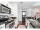 A modern kitchen featuring granite counters, stainless steel appliances, and white cabinetry for a sleek look at 700 S Harbour Island Blvd # 738, Tampa, FL 33602