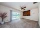 Spacious living room with a ceiling fan, sliding glass doors and built-in shelving at 708 Oak Ridge Dr, Brandon, FL 33510