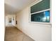 Exterior hallway with unit doors and patterned concrete floors at 7425 Bay Island S Dr # 202, South Pasadena, FL 33707