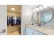 Bathroom vanity with granite counters adjacent to a walk-in closet at 7910 Sun Island S Dr # 305, South Pasadena, FL 33707