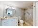 Bright bathroom features granite countertops, a vanity, and a walk-in shower at 7910 Sun Island S Dr # 305, South Pasadena, FL 33707