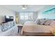 Bright bedroom boasts a waterfront view, beach decor, and a plush rug, creating a serene, stylish space at 7910 Sun Island S Dr # 305, South Pasadena, FL 33707