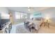 Bright bedroom with a view, a surfboard, and a comfortable seating area at 7910 Sun Island S Dr # 305, South Pasadena, FL 33707