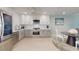Modern kitchen featuring stainless steel appliances and bright white cabinets at 7910 Sun Island S Dr # 305, South Pasadena, FL 33707