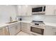 Modern kitchen featuring stainless steel appliances, quartz countertops, and stylish fixtures at 7910 Sun Island S Dr # 305, South Pasadena, FL 33707