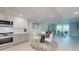 Open concept kitchen and living room with great natural light and access to balcony at 7910 Sun Island S Dr # 305, South Pasadena, FL 33707