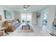 Well-lit living room with a comfortable sofa, tasteful decor, and access to a balcony at 7910 Sun Island S Dr # 305, South Pasadena, FL 33707