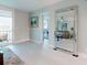 Spacious living area with a large mirror reflecting a cozy seating arrangement and scenic balcony views at 7910 Sun Island S Dr # 305, South Pasadena, FL 33707