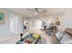 Open-concept space featuring light floors, plush seating, and a glimpse into the modern kitchen at 7910 Sun Island S Dr # 305, South Pasadena, FL 33707