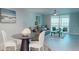 Open-concept living room features waterfront views, dining area, and neutral decor at 7910 Sun Island S Dr # 305, South Pasadena, FL 33707