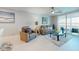 Inviting living room features a comfortable seating area, light floors, and balcony access at 7910 Sun Island S Dr # 305, South Pasadena, FL 33707