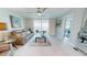 Bright living room with a comfortable sofa, stylish decor, and access to a balcony at 7910 Sun Island S Dr # 305, South Pasadena, FL 33707