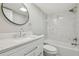 Renovated bathroom with white marble-style tile, vanity, and modern fixtures at 8408 Bob Wiggs Ave, Lithia, FL 33547