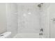 Clean, renovated bathroom featuring white tile and updated fixtures at 8408 Bob Wiggs Ave, Lithia, FL 33547