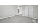 Spacious bedroom with modern vinyl plank flooring, ample closet space, and neutral color palette at 8408 Bob Wiggs Ave, Lithia, FL 33547