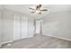 Bedroom featuring modern vinyl plank flooring, closet, ceiling fan, and neutral color scheme at 8408 Bob Wiggs Ave, Lithia, FL 33547