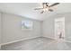 Bright bedroom with vinyl flooring, a ceiling fan, and an attached bathroom for convenience at 8408 Bob Wiggs Ave, Lithia, FL 33547