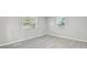 Bright bedroom with updated vinyl flooring and natural light from the two windows at 8408 Bob Wiggs Ave, Lithia, FL 33547