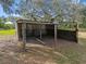 Exterior view of wooden carport with metal roof structure in the backyard at 8408 Bob Wiggs Ave, Lithia, FL 33547