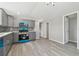 Modern kitchen featuring gray cabinets, stainless steel appliances, backsplash, and light-colored flooring at 8408 Bob Wiggs Ave, Lithia, FL 33547