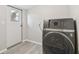 Laundry room featuring a modern washer and dryer with vinyl floors at 8408 Bob Wiggs Ave, Lithia, FL 33547