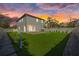 Exterior back of home at sunset features a large backyard at 902 W Sligh Ave, Tampa, FL 33604