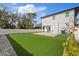 A sprawling, newly installed lawn highlights this backyard, complete with a covered porch at 902 W Sligh Ave, Tampa, FL 33604