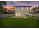 This backyard boasts a freshly manicured lawn and covered patio, great for outdoor entertaining at 902 W Sligh Ave, Tampa, FL 33604