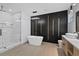 Luxurious bathroom with a free-standing tub, walk-in shower, and modern vanity at 902 W Sligh Ave, Tampa, FL 33604