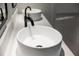 Close-up view of modern bathroom sink with matte black faucet and white countertop at 902 W Sligh Ave, Tampa, FL 33604