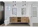 Modern bathroom featuring double sinks, floating vanity, and unique light fixtures at 902 W Sligh Ave, Tampa, FL 33604