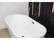 Close up of a modern soaking tub with black fixtures at 902 W Sligh Ave, Tampa, FL 33604