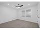 Empty bedroom featuring wood-look floors, a ceiling fan, and modern window shades at 902 W Sligh Ave, Tampa, FL 33604