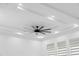 A modern ceiling fan graces the all-white ceiling and recessed lighting near the large windows at 902 W Sligh Ave, Tampa, FL 33604