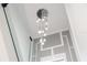 Modern chandelier with raindrop lights hanging from the ceiling above the staircase with a custom feature wall at 902 W Sligh Ave, Tampa, FL 33604
