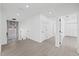 Upstairs hallway featuring wood-look flooring, modern chandelier, and white doors and trim at 902 W Sligh Ave, Tampa, FL 33604