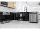 This kitchen features a sleek black cooktop, stainless steel appliances, and modern faucet at 902 W Sligh Ave, Tampa, FL 33604