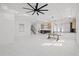 Bright, open-concept living space with stairs, modern kitchen, and unique light fixtures and marble floors at 902 W Sligh Ave, Tampa, FL 33604