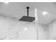 A modern shower features glass doors and a rainfall shower head at 902 W Sligh Ave, Tampa, FL 33604