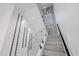 Modern staircase features glass railing and unique wall design, adding a touch of elegance at 902 W Sligh Ave, Tampa, FL 33604