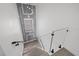 Modern staircase with wood-look steps, glass railing, and decorative gray wall with white trim at 902 W Sligh Ave, Tampa, FL 33604