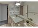 Traditional bathroom featuring an extended mirror, ceramic tiles, and a combined bath and shower at 1290 Clays Trl, Oldsmar, FL 34677