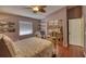 Comfortable bedroom with hardwood floors, a ceiling fan, and neutral walls at 1290 Clays Trl, Oldsmar, FL 34677